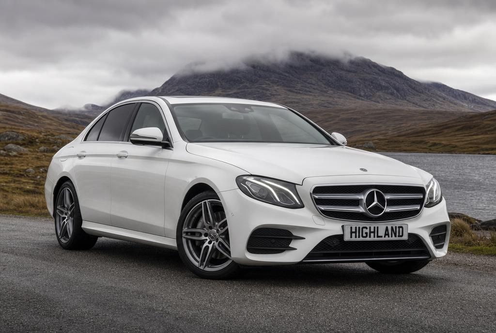 White Mercedes-Benz E-Class with HIGHLAND plate on a Highland road