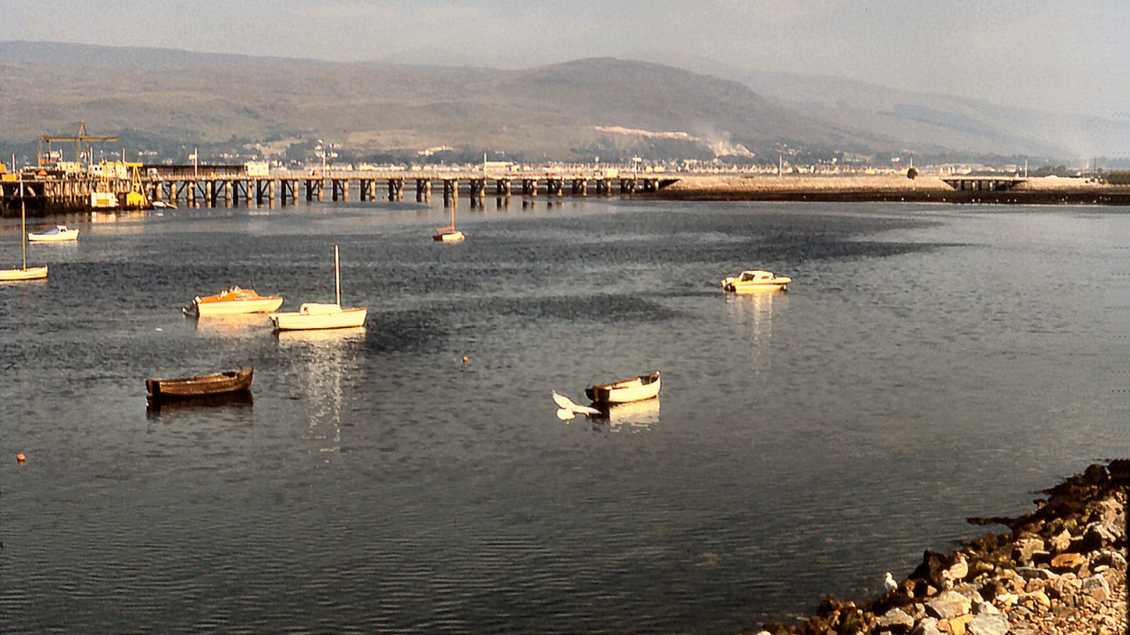 Fort William's waterfront and pier with the mountains of Lochaber beyond — airport transfers from Fort William